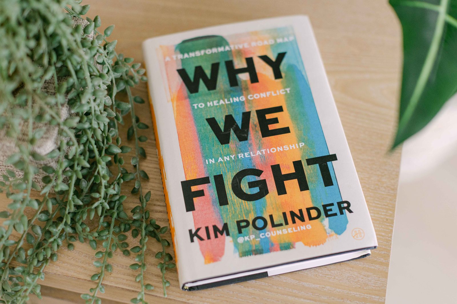 Why We Fight by Kim Polinder beside a plant